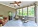 Enclosed sunroom featuring tiled floors, wood plank walls and windows at 3581 Boulder Ct, Wake Forest, NC 27587