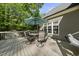 Spacious backyard deck with umbrella-shaded dining and a relaxing hammock, ideal for outdoor living at 359 Heather Bluffs Dr, Garner, NC 27529