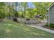 A well-manicured backyard featuring a spacious deck, patio, and lush lawn at 359 Heather Bluffs Dr, Garner, NC 27529