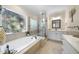 A luxurious bathroom featuring a jacuzzi tub under a decorative glass window and a glass walk-in shower at 359 Heather Bluffs Dr, Garner, NC 27529