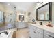 Spacious bathroom with double vanities, a soaking tub, and a separate glass-enclosed shower at 359 Heather Bluffs Dr, Garner, NC 27529