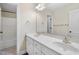Bright bathroom with double sinks, white cabinets, marble countertops, and a combined shower-tub, designed for functionality at 359 Heather Bluffs Dr, Garner, NC 27529