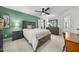Bedroom featuring rustic furniture, a green accent wall, and a walk-in closet at 359 Heather Bluffs Dr, Garner, NC 27529