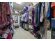 Walk-in closet with shelves and hanging rods, filled with clothes and accessories at 359 Heather Bluffs Dr, Garner, NC 27529