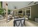 Relaxing covered patio with comfortable seating, outdoor TV, and views of the lush greenery at 359 Heather Bluffs Dr, Garner, NC 27529
