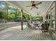 Inviting covered patio featuring a ceiling fan, comfortable seating, and view of the gazebo and pool at 359 Heather Bluffs Dr, Garner, NC 27529