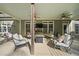 Serene covered patio with a cozy fire pit, plush seating, and an outdoor television for entertainment at 359 Heather Bluffs Dr, Garner, NC 27529