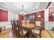 Formal dining room with a beautiful chandelier, china cabinet and a large window with natural light at 359 Heather Bluffs Dr, Garner, NC 27529