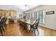 Open dining room with hardwood floors, a large window, and a view of the kitchen at 359 Heather Bluffs Dr, Garner, NC 27529