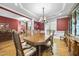 Elegant dining room with a large table, ornate chandelier, and views into adjacent living spaces at 359 Heather Bluffs Dr, Garner, NC 27529
