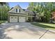 Charming two-story home featuring a three car garage and manicured lawn at 359 Heather Bluffs Dr, Garner, NC 27529