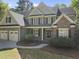 Traditional-style home featuring a well-maintained lawn and a three-car garage at 359 Heather Bluffs Dr, Garner, NC 27529