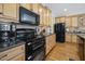 Kitchen featuring stainless appliances, wood cabinets, tile backsplash, and hardwood flooring at 359 Heather Bluffs Dr, Garner, NC 27529