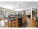 Spacious kitchen featuring granite countertops, stainless appliances, and seamless access to living room at 359 Heather Bluffs Dr, Garner, NC 27529