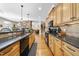 This kitchen offers great flow, granite counters, wood cabinets, and access to the living area at 359 Heather Bluffs Dr, Garner, NC 27529