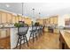 Kitchen island with wood cabinets, granite countertops, and barstool seating at 359 Heather Bluffs Dr, Garner, NC 27529