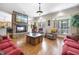 Living room with stone fireplace, hardwood floors, and natural light from large windows at 359 Heather Bluffs Dr, Garner, NC 27529
