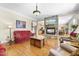 Open concept living room featuring a stone fireplace, hardwood floors, and a view of the kitchen at 359 Heather Bluffs Dr, Garner, NC 27529