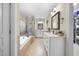 Bright bathroom featuring double vanities, a soaking tub, and a walk-in shower at 359 Heather Bluffs Dr, Garner, NC 27529