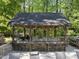Covered outdoor kitchen and dining area with built-in grill and seating at 359 Heather Bluffs Dr, Garner, NC 27529