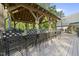 Well-equipped outdoor kitchen with granite counters and seating under a charming, covered pergola at 359 Heather Bluffs Dr, Garner, NC 27529