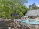 Backyard pool with a water basketball goal surrounded by trees and lounge chairs at 359 Heather Bluffs Dr, Garner, NC 27529
