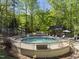 A backyard pool with wooden fence, lounge chairs, and a gazebo at 359 Heather Bluffs Dr, Garner, NC 27529