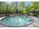 Sparkling above-ground pool surrounded by a wooden deck and lush greenery, perfect for summer fun at 359 Heather Bluffs Dr, Garner, NC 27529