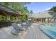 Stunning poolside view highlighting the outdoor lounge chairs, gazebo, and expansive deck for entertaining at 359 Heather Bluffs Dr, Garner, NC 27529