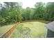 Aerial view of the large backyard, featuring healthy green grass and a tall wooden fence at 3804 Delves Ln, Raleigh, NC 27616