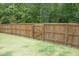 Close-up view of the backyard's tall wooden privacy fence and gate at 3804 Delves Ln, Raleigh, NC 27616