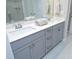 Bathroom featuring double sink vanity with gray cabinets and a large mirror at 3804 Delves Ln, Raleigh, NC 27616