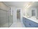 Bathroom with glass shower, double sink vanity, and open doorway to walk in closet at 3804 Delves Ln, Raleigh, NC 27616