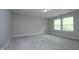 This bedroom features neutral walls, plush carpet, and natural light from two windows at 3804 Delves Ln, Raleigh, NC 27616
