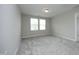 Bedroom with neutral walls, carpeted floor, and plenty of natural light from the two windows at 3804 Delves Ln, Raleigh, NC 27616
