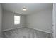 A cozy bedroom featuring neutral walls, plush carpet, and natural light at 3804 Delves Ln, Raleigh, NC 27616