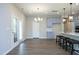 Bright eat-in kitchen features gray cabinets, a center island with bar stool seating, and modern light fixtures at 3804 Delves Ln, Raleigh, NC 27616