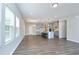 Open-concept kitchen and dining area features an island with bar seating and stainless steel appliances at 3804 Delves Ln, Raleigh, NC 27616