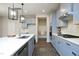 Modern kitchen with stainless steel appliances, gray cabinets, a tiled backsplash, and an island with bar seating at 3804 Delves Ln, Raleigh, NC 27616