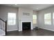 Cozy living room features a fireplace, hardwood floors, neutral walls, and a large window for natural light at 3804 Delves Ln, Raleigh, NC 27616