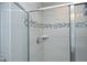 Modern shower with glass door, tiled walls, and a decorative tile accent at 3804 Delves Ln, Raleigh, NC 27616