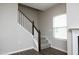 Carpeted staircase with dark wood railing and white spindles leads to the upper level at 3804 Delves Ln, Raleigh, NC 27616