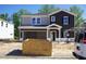 Two-story home with a gray and dark color scheme, attached garage, and covered entry at 3845 Rosebush Dr, Zebulon, NC 27597