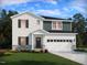 Charming two-story home with a well-manicured lawn and a two-car garage at 3845 Rosebush Dr, Zebulon, NC 27597