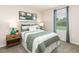 Cozy bedroom featuring neutral walls, carpet floors, and a window overlooking the landscape at 3853 Rosebush Dr, Zebulon, NC 27597