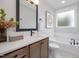 Relaxing bathroom features a soaking tub, stylish vanity, and a bright window, creating a spa-like atmosphere at 3922 Lost Fawn Ct, Raleigh, NC 27612