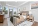 Bright bedroom features a plush bed, stylish decor, and a door to a balcony, creating a serene and inviting space at 3922 Lost Fawn Ct, Raleigh, NC 27612