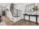 Modern entryway with stylish decor, featuring a staircase, contemporary console table, and decorative mirror at 3922 Lost Fawn Ct, Raleigh, NC 27612