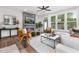 Cozy living room with modern fireplace, ample natural light, neutral decor and hardwood flooring at 3922 Lost Fawn Ct, Raleigh, NC 27612