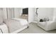 Comfortable primary bedroom featuring soft neutral tones, a sitting area, and an en-suite bathroom for added convenience at 3926 Lost Fawn Ct, Raleigh, NC 27612